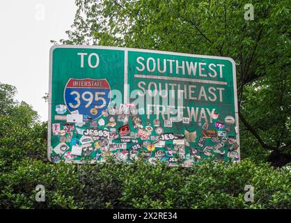 The highway sign for Interstate 395 in Washington DC has a few stickers on it. Stock Photo
