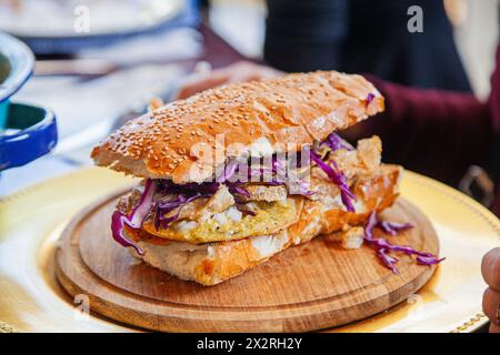 Delicious cake filled with pork crackling and accompanied by fresh sauce with a little spice. Stock Photo