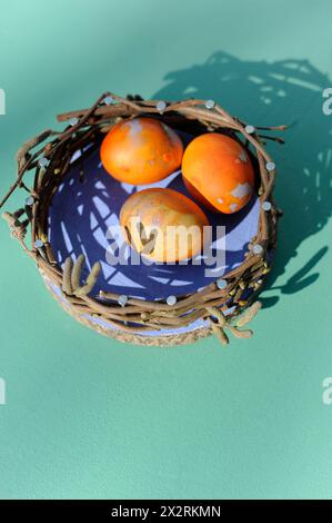 Chicken eggs in DIY decorative Easter nest Stock Photo