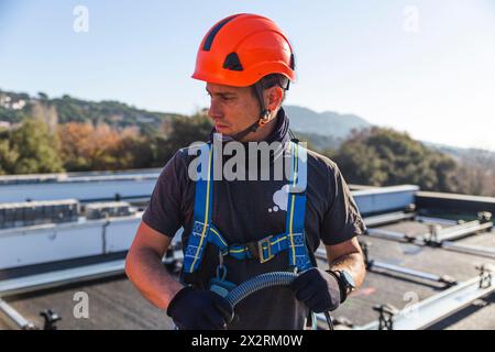 Mature technician wearing protective workwear on sunny day Stock Photo
