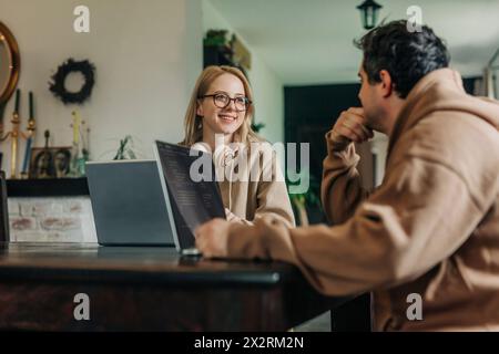 Software programmers talking near laptop at home office Stock Photo