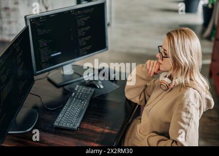 Thoughtful computer programmer working at home office Stock Photo