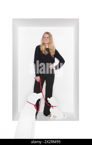 Teenage girl with dog cut out standing against white background Stock Photo