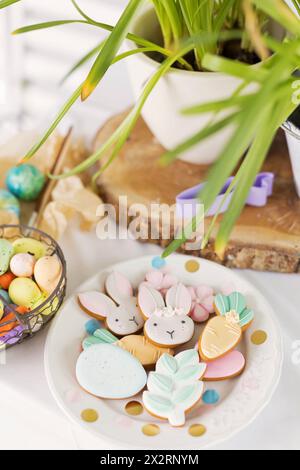 Easter cookies in plate with eggs on table Stock Photo