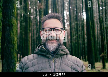 Bearded man wearing eyeglasses in forest Stock Photo
