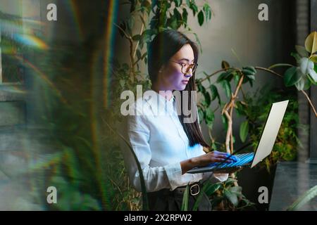 Businesswoman working on laptop in office Stock Photo