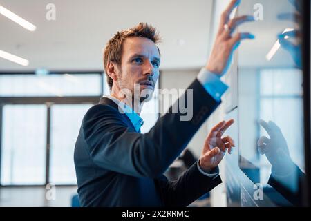 Businessman working on computer in office Stock Photo