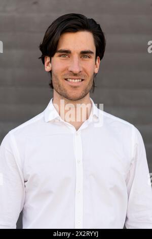 Smiling young businessman in white shirt Stock Photo