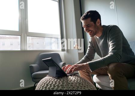 Smiling businessman working on tablet PC in office Stock Photo