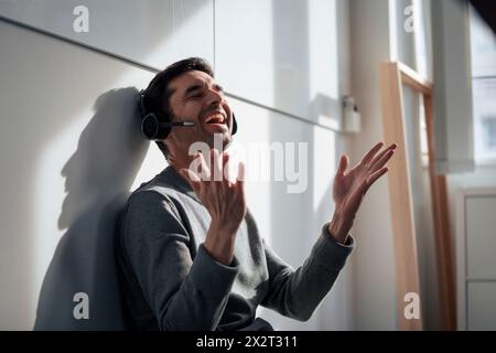 Cheerful mature businessman talking on headset Stock Photo