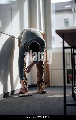 Businessman bending and writing with digitized pen on tablet PC Stock Photo