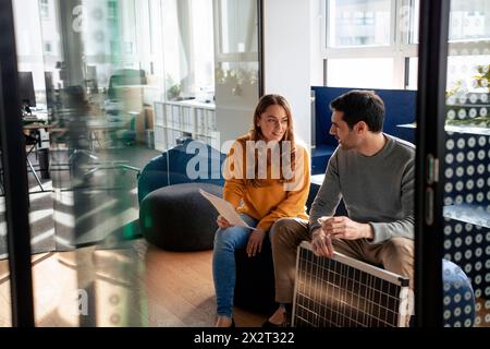 Business people discussing and sitting with solar panel in office Stock Photo