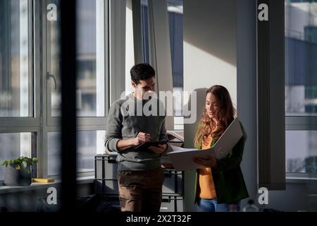 Mature business people discussing over documents in office Stock Photo