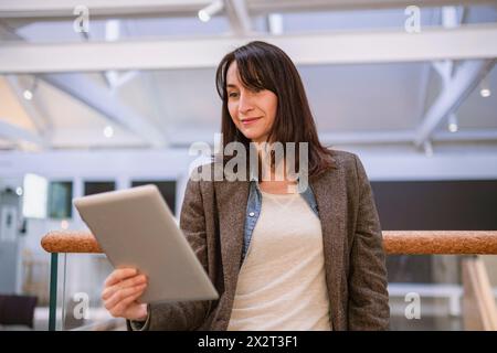 Smiling mature woman using tablet PC Stock Photo