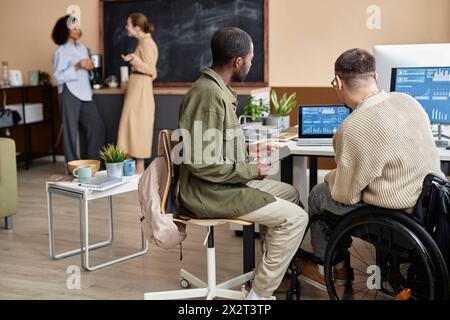 Computer programmers working over new software on laptop in office Stock Photo