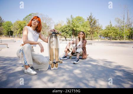 Young skaters posing together at skateboard park Stock Photo