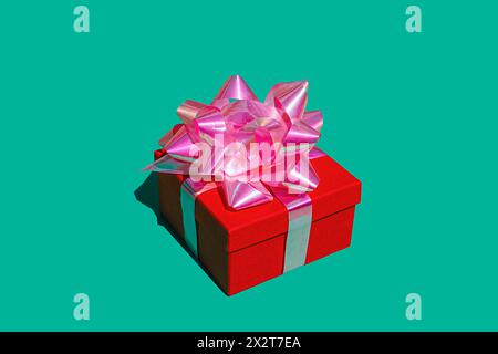 Red gift box against green background Stock Photo