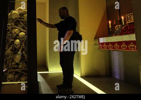 Beirut, Beirut, Lebanon. 23rd Apr, 2024. A Lebanese Armenian prays inside the cemetery of Armenians who were executed by Ottoman Turks, during a memorial service at the Armenian Church Catholicosate of Cilicia north of Beirut on the eve of the 109th anniversary of the Armenian Genocide that was carried out in 1915-1917 by the Ottoman Empire and its then ruling party, the Committee of Union and Progress, during World War I. April 24 will mark the 109th anniversary of the Armenian Genocide, when more than 1.5 million Armenians were systematically exterminated by the Ottoman Turks, an event that Stock Photo