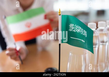 Flags of Iran and Saudi Arabia stand on negotiating table in office Stock Photo