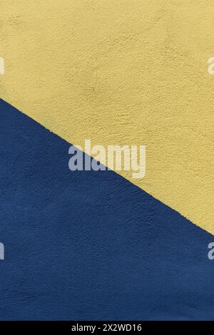 Colored paper in blue and yellow, divided in half, diagonally background 1 Stock Photo