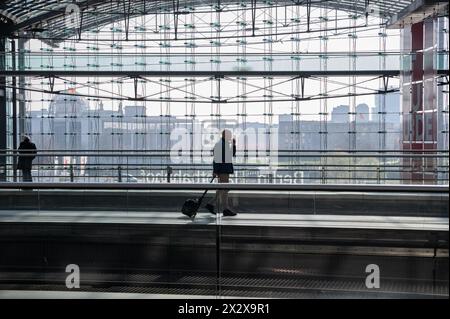 07.03.2024, Berlin, , Germany - Europe - A train passenger walks across a platform in Berlin's almost deserted central station during a strike by the Stock Photo