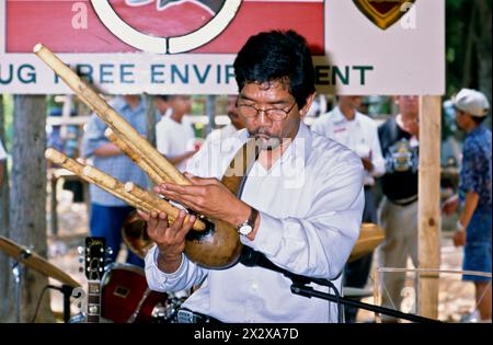 An ethnic Ede man playing a traditional musical instrument at a festival of indigenous Vietnamese culture in North Carolina, United States. Stock Photo