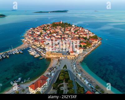 Primosten, Croatia - Aerial view of the old town of Primosten peninsula, St. George's Church on a sunny summer morning in Dalmatia, Croatia. Blue and Stock Photo