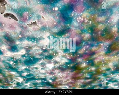 Abstract texture background of soap and water designs on a vehicle windshield in an automated car wash Stock Photo