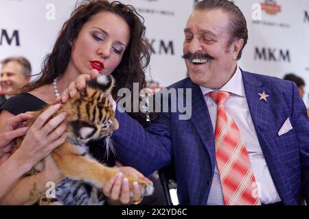 MOSCOW - OCT 22: Circus actress, tamer, animal trainer Karina Bagdasarova with tiger cub and american and russian singer Willy Tokarev at Phoney New Y Stock Photo