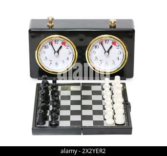 Chess timer and chess board with figures isolated on white background. Stock Photo