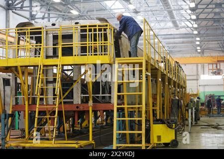 MYTISHCHI - APR 18: Workers on stocks in shop floor at  Mytishchi Metrovagonmash factory, April 18, 2012, Mytishchi, Russia. The plant is famous for c Stock Photo