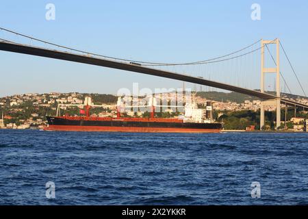 ISTANBUL - JUL 3: Landscape with barge and Ataturk Bridge (Bosphorus Bridge) at sunset on July 3, 2012 in Istanbul, Turkey. Ataturk Bridge is a first Stock Photo