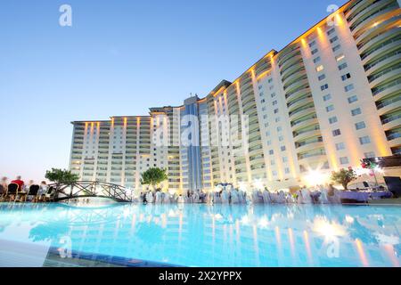 ALANYA - JULY 5: Pool and people on party near Goldcity hotel, on July 5, 2012 in Alanya, Turkey. Goldcity complex has football field, playgrounds for Stock Photo