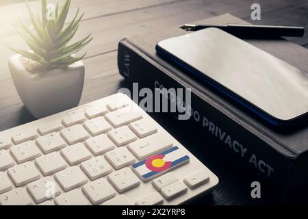 CPA (Colorado Privacy Act) concept: a book and a computer keyboard with colorado flag Stock Photo