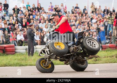 MOSCOW - AUG 25: Man stunt shows on a quad bike on Festival of art and film stunt Prometheus in Tushino on August 25, 2012 in Moscow, Russia. The fest Stock Photo