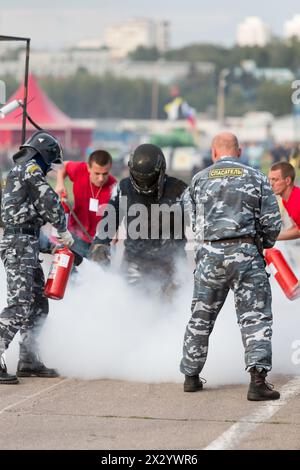 MOSCOW - AUG 25: Rescue workers extinguish a stunt man after ignition on Festival of art and film stunt Prometheus in Tushino on August 25, 2012 in Mo Stock Photo