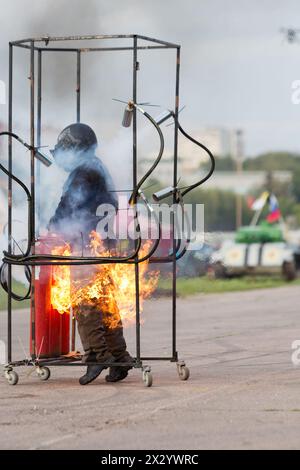 MOSCOW - AUG 25: Extinguish after a stunt man ignition on Festival of art and film stunt Prometheus in Tushino on August 25, 2012 in Moscow, Russia. T Stock Photo