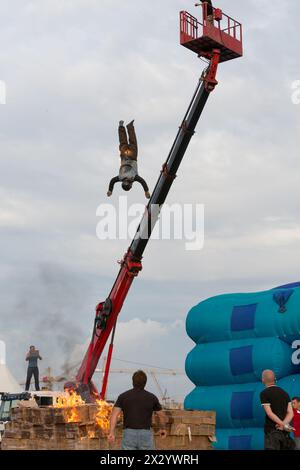 MOSCOW - AUG 25: Man jumping from a height into the burning box on Festival of art and film stunt Prometheus in Tushino on August 25, 2012 in Moscow, Stock Photo