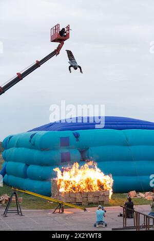 MOSCOW - AUG 25: Man jumping from a height into the burning box on Festival of art and film stunt Prometheus in Tushino on August 25, 2012 in Moscow, Stock Photo