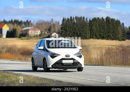 White Toyota Aygo city car, Second generation facelift model, at speed on highway. Salo, Finland. April 19, 2024. Stock Photo