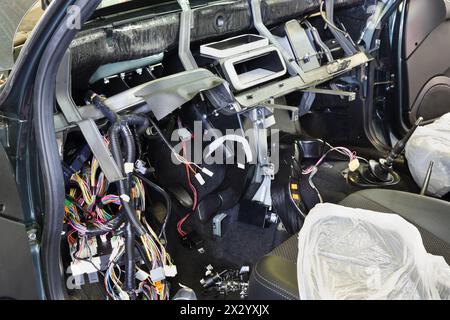 Disassembled console in car at checkout - lot of multicolored wires. Stock Photo