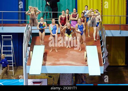 MOSCOW - APR 13:  Female athletes perform syncronized jump in Pool of SC Olympic on day of third phase of the World Series of FINA Diving, April 13, 2 Stock Photo