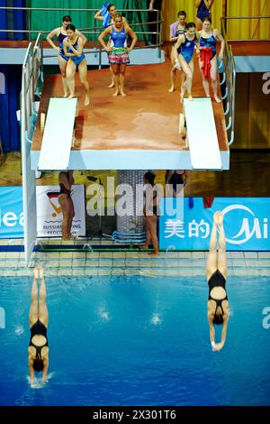 MOSCOW - APR 13:  Female athletes during competitions on  syncronized springboard diving in Pool of SC Olympic on day of third phase of the World Seri Stock Photo
