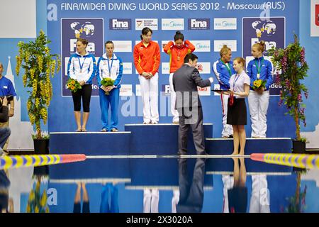 MOSCOW - APR 13:  Female athletes during awarding at Pool of SC Olympic on day of third phase of the World Series of FINA Diving, April 13, 2012, Mosc Stock Photo