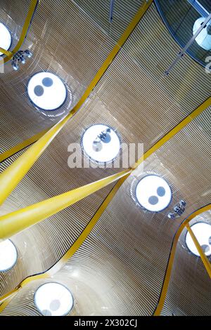 Row of round lamps on futuristic yellow ceiling with curves. Stock Photo