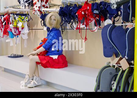 Sitting female fashion doll in clothing store Stock Photo