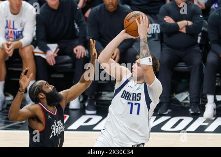 Los Angeles, USA. 23rd Apr, 2024. Dallas Mavericks' Luka Doncic (R) shoots the ball during the NBA first-round playoff match between Los Angeles Clippers and Dallas Mavericks in Los Angeles, the United States, April 23, 2024. Credit: Zhao Hanrong/Xinhua/Alamy Live News Stock Photo