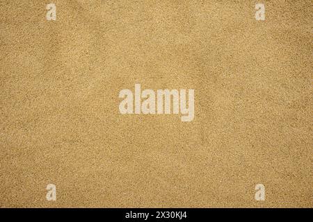 Close-up of smooth beige sand texture, ideal for backgrounds or overlay Stock Photo
