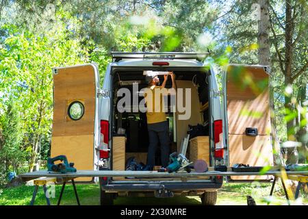 Man working camperizing a camper van Stock Photo