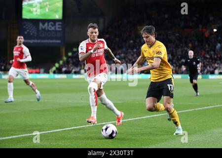 WOLVERHAMPTON, ENGLAND - APRIL 20: Hugo Bueno of Wolverhampton Wanderers and Ben White of Arsenal during the Premier League match between Wolverhampton Wanderers and Arsenal FC at Molineux on April 20, 2024 in Wolverhampton, England.(Photo by MB Media/MB Media) Stock Photo